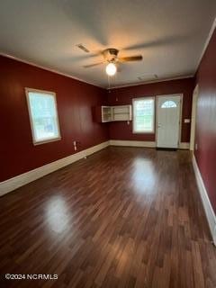 unfurnished room with ornamental molding, dark hardwood / wood-style flooring, and ceiling fan