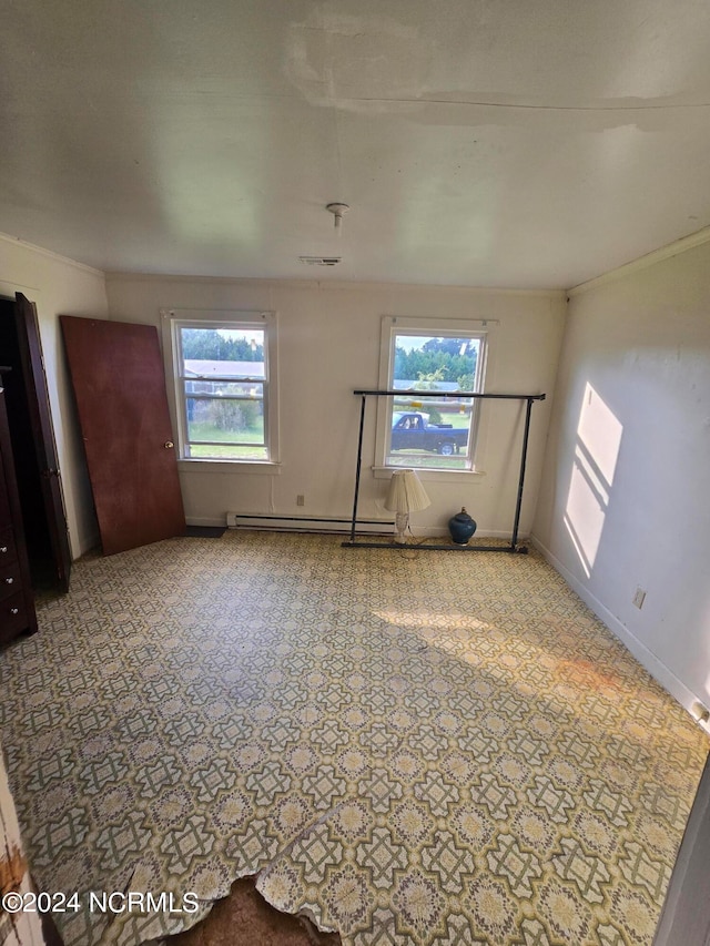 interior space with multiple windows, ornamental molding, and baseboard heating