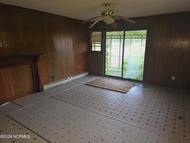 foyer featuring wood walls, ceiling fan, and a baseboard radiator