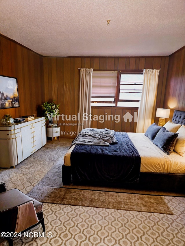 bedroom with wood walls and a textured ceiling