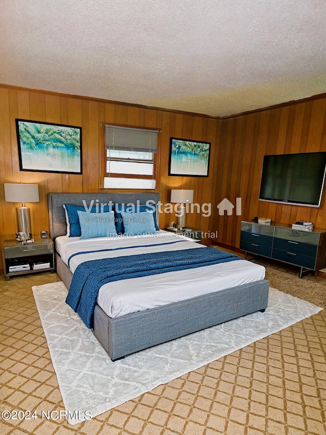 bedroom with wood walls and a textured ceiling