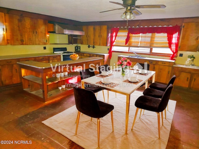 kitchen with white range, ceiling fan, and wall chimney range hood