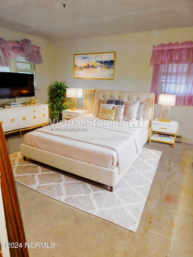 carpeted bedroom with a textured ceiling