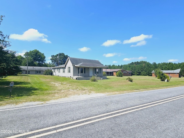 view of front of home with a front yard and covered porch