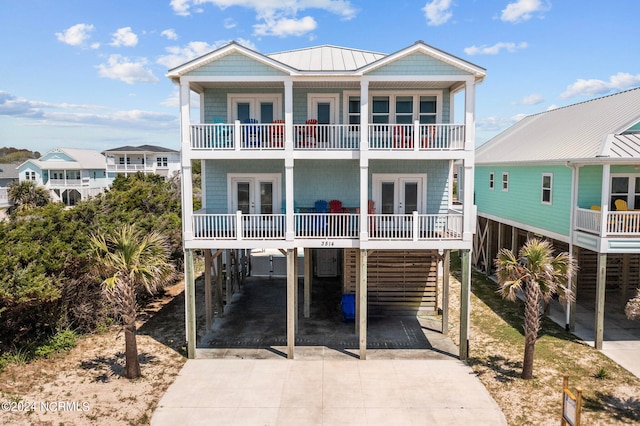 view of front of home featuring a balcony and a carport