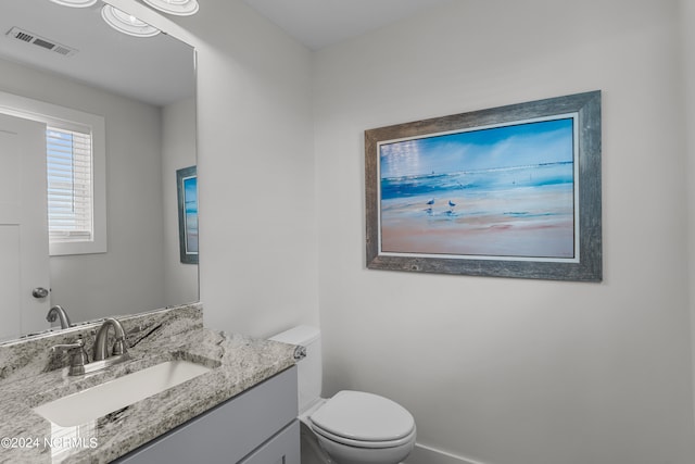 bathroom featuring vanity and toilet