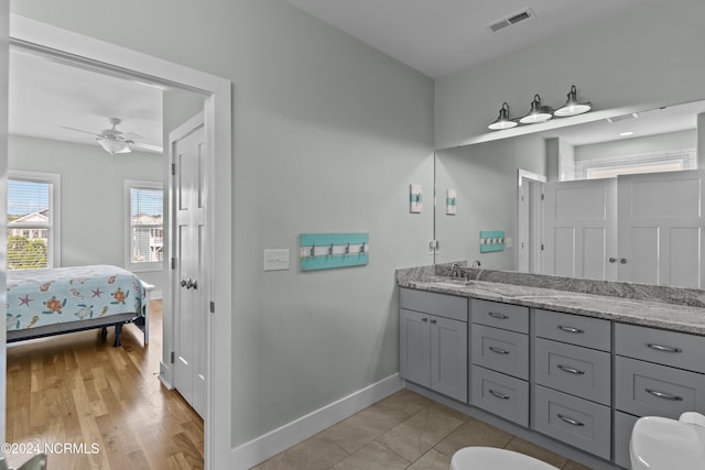 bathroom featuring ceiling fan, vanity, and hardwood / wood-style floors