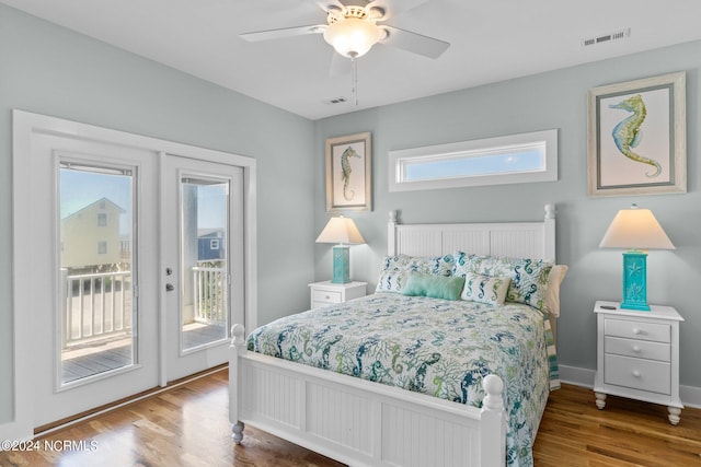 bedroom with ceiling fan, multiple windows, wood-type flooring, and access to outside