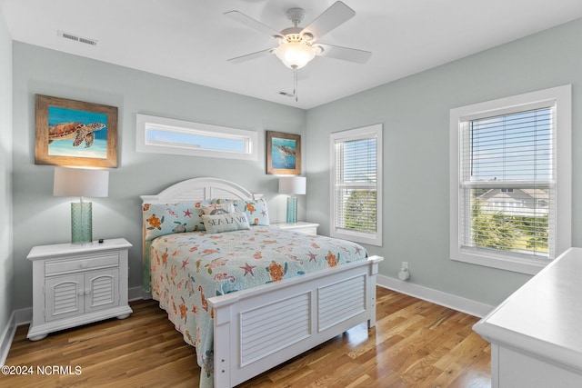 bedroom with ceiling fan and wood-type flooring