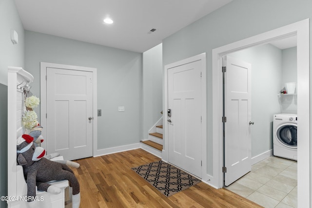 entryway with light wood-type flooring and washer / clothes dryer