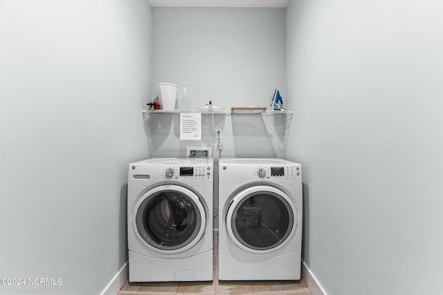 laundry room with light tile patterned floors and washer and dryer