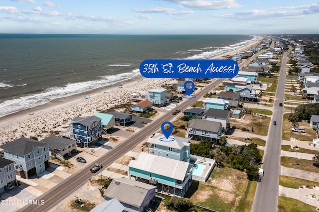 birds eye view of property featuring a water view and a view of the beach