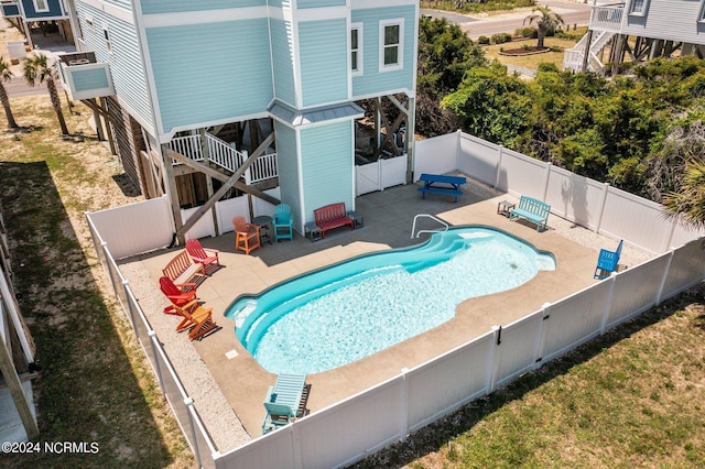 view of swimming pool with a patio