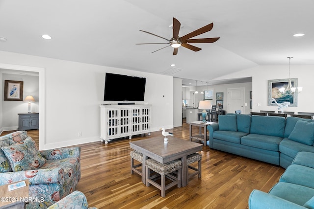 living room featuring ceiling fan with notable chandelier, lofted ceiling, and hardwood / wood-style floors