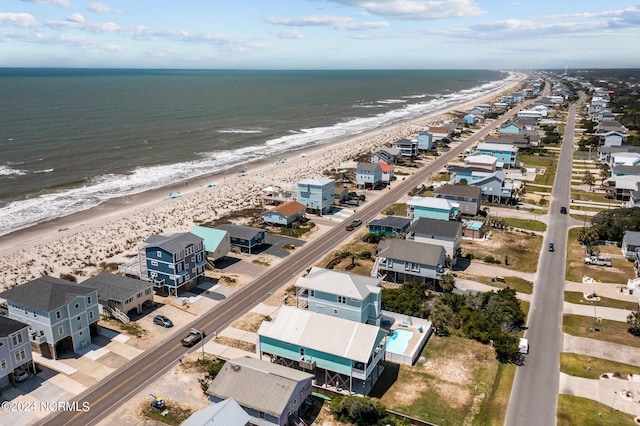 birds eye view of property with a beach view and a water view