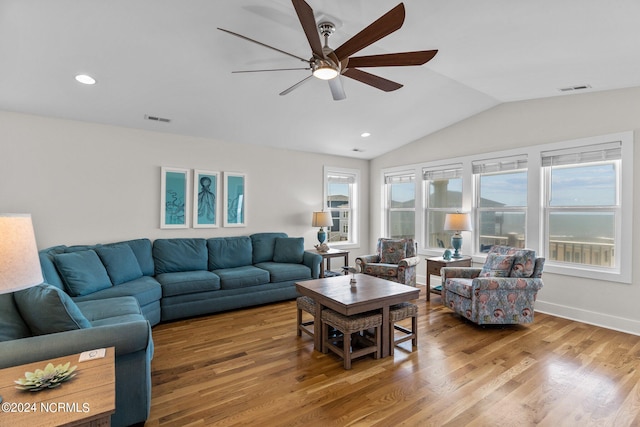 living room with ceiling fan, vaulted ceiling, hardwood / wood-style floors, and a wealth of natural light