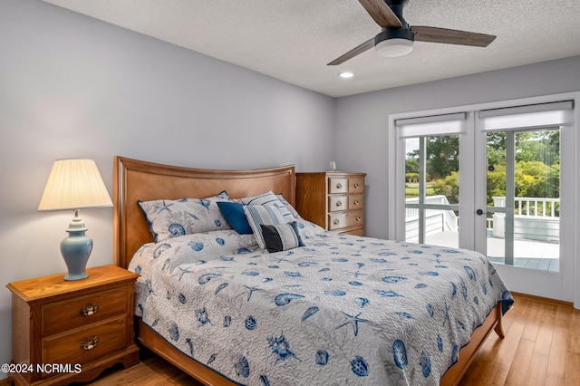 bedroom featuring access to outside, a textured ceiling, light hardwood / wood-style floors, and ceiling fan