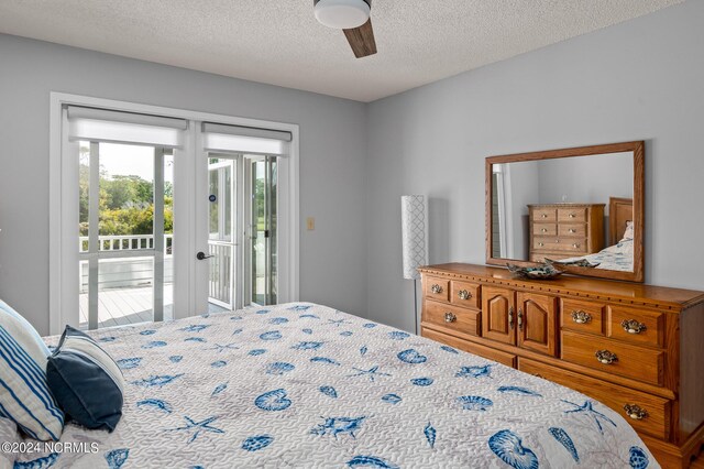 bedroom featuring ceiling fan, a textured ceiling, and access to exterior