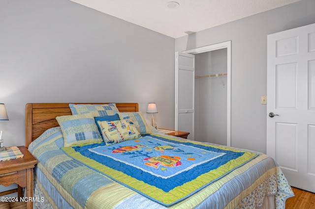 bedroom featuring hardwood / wood-style flooring and a closet