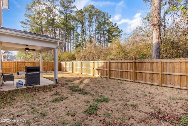 view of yard with ceiling fan and a patio area