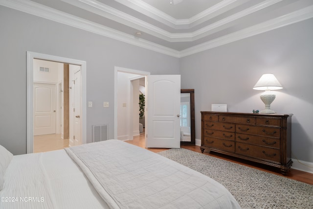 bedroom with light wood-type flooring and ornamental molding