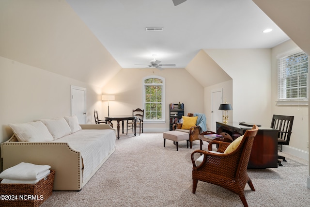 carpeted living room with ceiling fan and lofted ceiling