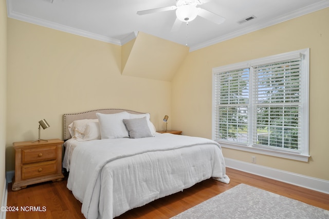 bedroom featuring hardwood / wood-style flooring, ceiling fan, and crown molding