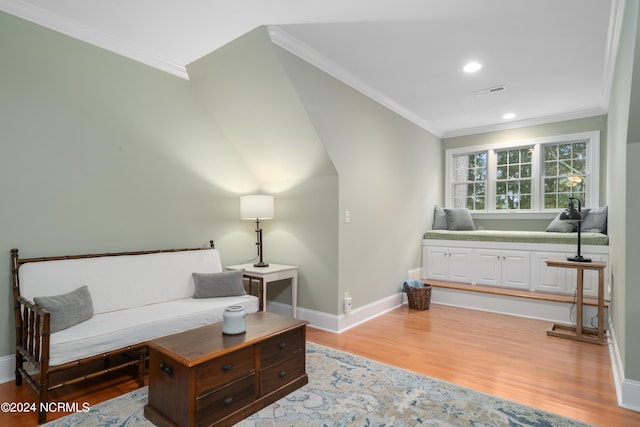 living room featuring hardwood / wood-style flooring and crown molding