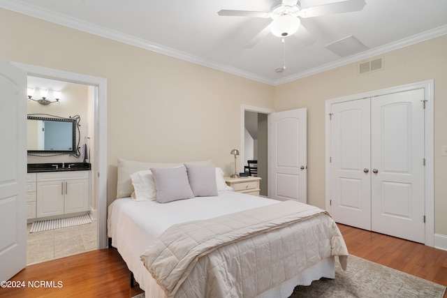 bedroom featuring hardwood / wood-style flooring, ceiling fan, crown molding, and a closet