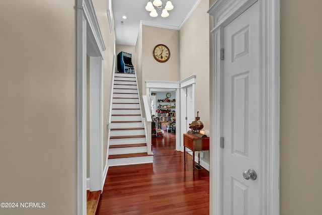 entryway with ornamental molding and dark hardwood / wood-style flooring