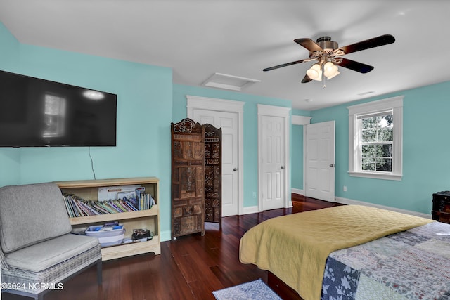 bedroom featuring visible vents, baseboards, ceiling fan, attic access, and wood finished floors