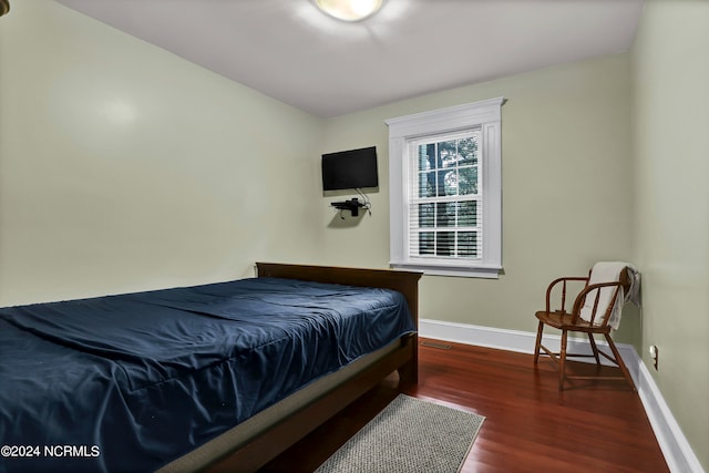 bedroom featuring dark hardwood / wood-style flooring