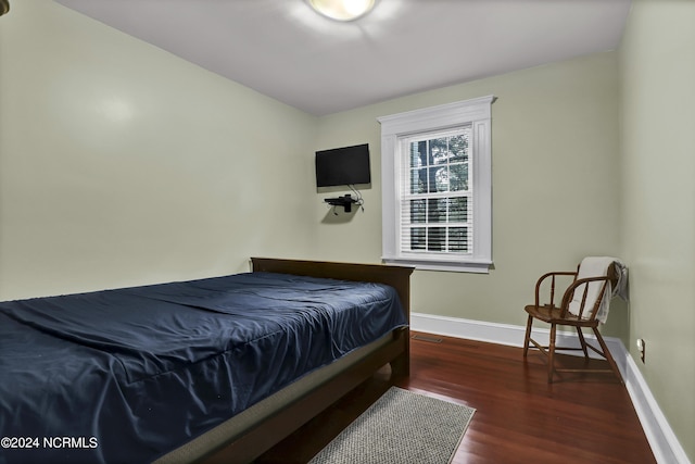bedroom featuring baseboards and wood finished floors