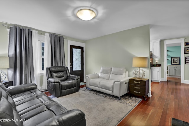 living area featuring dark wood-style floors and baseboards