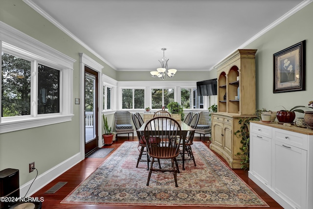 dining room with a notable chandelier, baseboards, crown molding, and dark wood finished floors