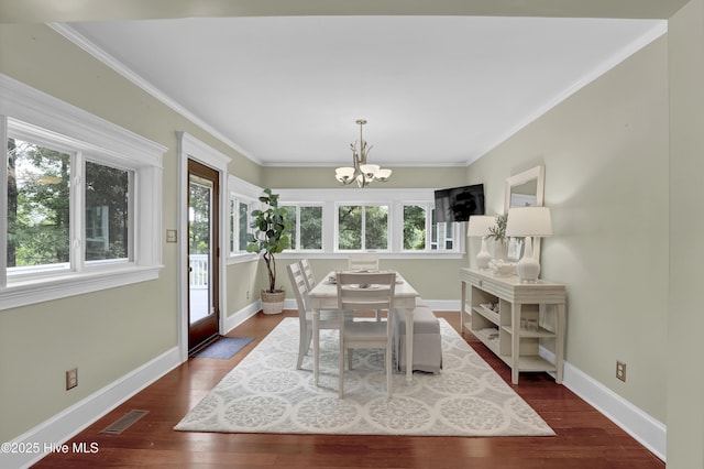 204 Van Riggs Rd, Hubert, NC 28539 - dining space featuring healthy amount of natural light, a chandelier, dark wood-style floors, and ornamental molding