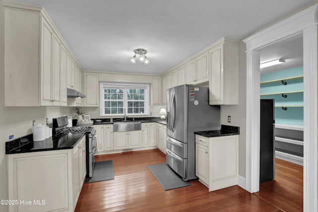 204 Van Riggs Rd, Hubert, NC 28539 - kitchen featuring stainless steel appliances, under cabinet range hood, dark wood-type flooring, and dark stone counters