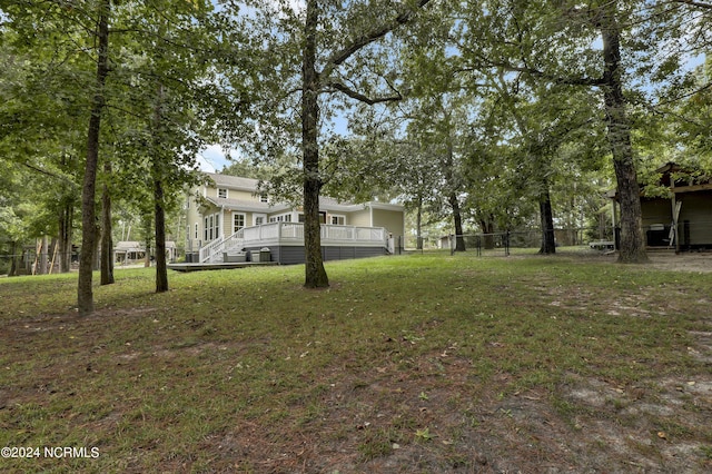 view of yard with a wooden deck and fence