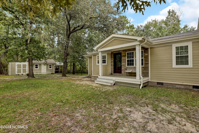 exterior space featuring a lawn and covered porch