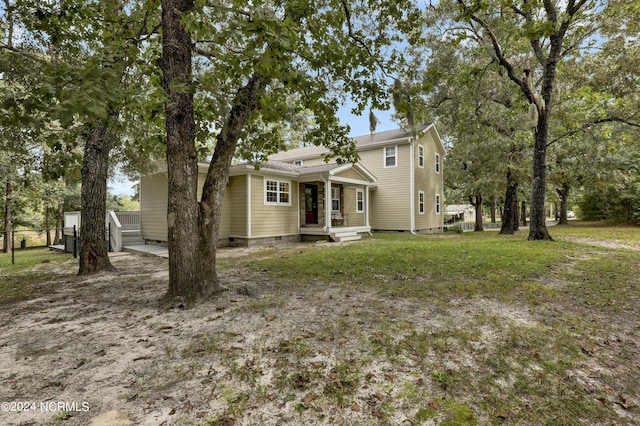 view of front facade with crawl space, a front yard, and fence