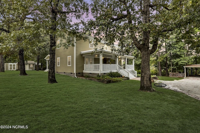 view of front of house with crawl space, covered porch, a front yard, and dirt driveway