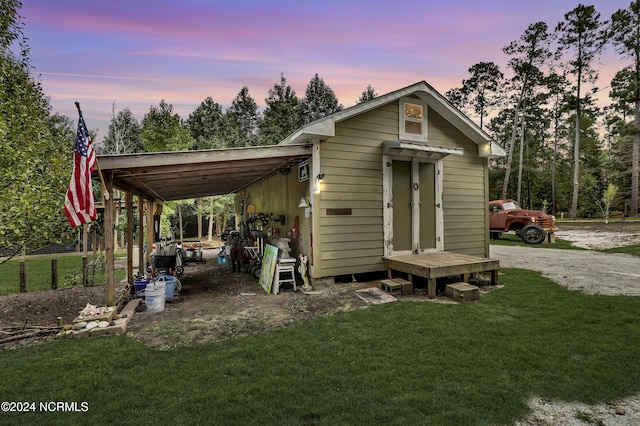 exterior space with an outbuilding, driveway, and an attached carport