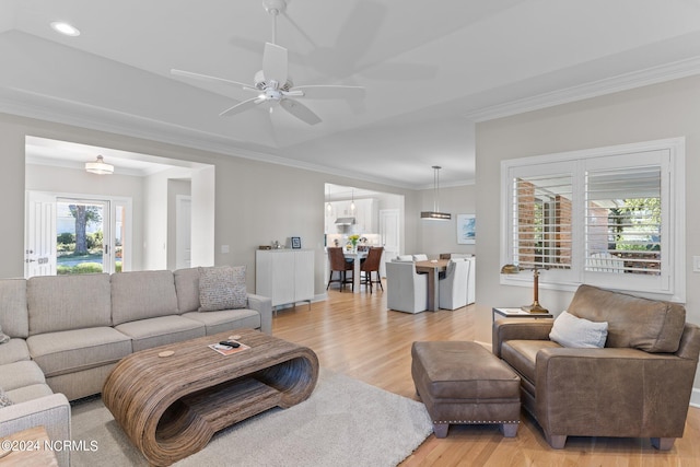 living room featuring light hardwood / wood-style floors, a wealth of natural light, and ceiling fan