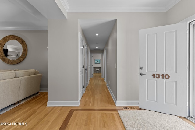 hall featuring ornamental molding and hardwood / wood-style floors