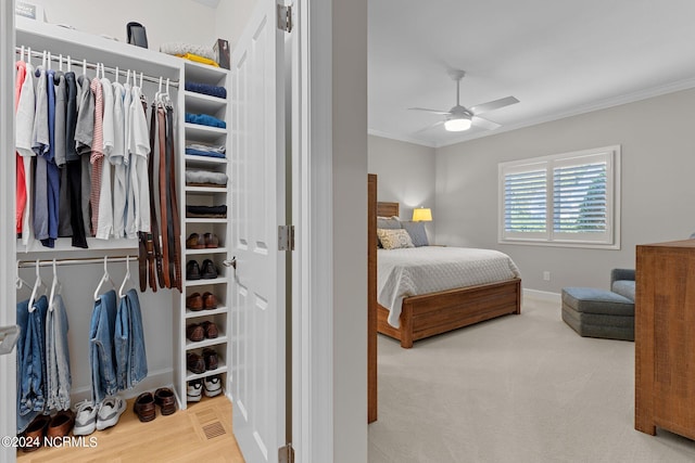 bedroom with ceiling fan, crown molding, and carpet flooring