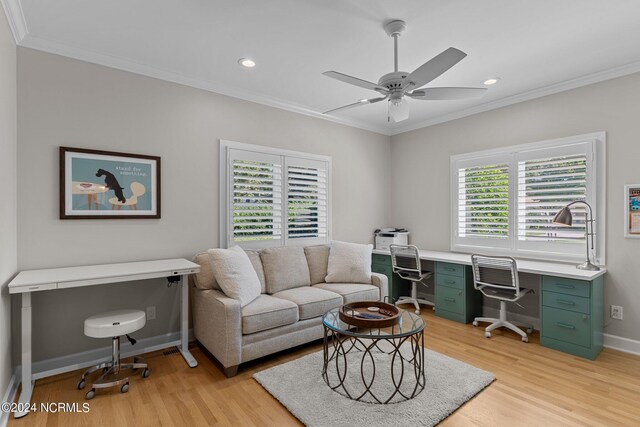 office space featuring ornamental molding, ceiling fan, and light hardwood / wood-style flooring