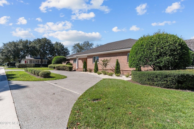 ranch-style house with a front lawn