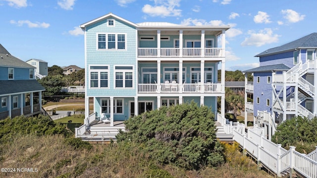 back of property with a balcony