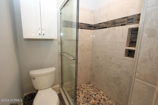 bathroom with walk in shower and toilet