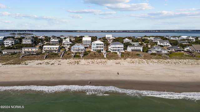 birds eye view of property with a water view and a view of the beach